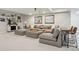 Spacious basement with a cozy seating area, stone fireplace, and custom bar at 6361 Kenzie Cir, Castle Pines, CO 80108