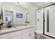 Elegant bathroom with a glass-enclosed shower, patterned tile floor, and ample counter space at 6361 Kenzie Cir, Castle Pines, CO 80108