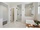 Beautiful bathroom showcasing a glass-enclosed shower, soaking tub, and modern tile flooring at 6361 Kenzie Cir, Castle Pines, CO 80108