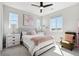 Charming bedroom with soft pastel accents, a plush bed, and abundant natural light at 6361 Kenzie Cir, Castle Pines, CO 80108