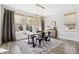 Sun-filled dining room with modern light fixture and view of the beautiful outdoors at 6361 Kenzie Cir, Castle Pines, CO 80108