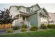 Two-story home with a well-kept lawn, covered porch, and green and white siding, creating a welcoming curb appeal at 6361 Kenzie Cir, Castle Pines, CO 80108