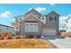 Charming two-story home with a two-car garage and well-maintained lawn at 6361 Kenzie Cir, Castle Pines, CO 80108