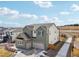 Two-story home with a gray roof, green and white siding, a two car garage, and well-maintained landscaping at 6361 Kenzie Cir, Castle Pines, CO 80108