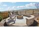 Backyard stone fire pit and outdoor seating area at 6361 Kenzie Cir, Castle Pines, CO 80108
