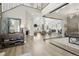 Bright foyer with hardwood floors, staircase, decorative mirror, and glass-enclosed office at 6361 Kenzie Cir, Castle Pines, CO 80108
