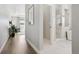 Hallway view of a bathroom and bedroom with an open-concept design and hardwood floors at 6361 Kenzie Cir, Castle Pines, CO 80108