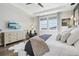 Cozy main bedroom showcasing hardwood floors, natural light, and a comfy seating area at 6361 Kenzie Cir, Castle Pines, CO 80108