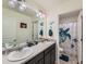 Shared bathroom with double vanity and decorative touches at 2300 Mountain Sky Dr, Fort Lupton, CO 80621