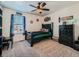 Bedroom with carpet flooring, ceiling fan, neutral paint and furniture plus a large window at 2300 Mountain Sky Dr, Fort Lupton, CO 80621