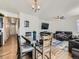 Open concept dining area with hardwood floors and adjacent living room at 2300 Mountain Sky Dr, Fort Lupton, CO 80621