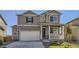 Two-story house with a large garage and well-maintained lawn at 2300 Mountain Sky Dr, Fort Lupton, CO 80621