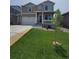 Charming two-story home featuring a covered front porch and a well-manicured lawn with a spacious two car garage at 2300 Mountain Sky Dr, Fort Lupton, CO 80621