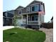 Charming two-story home featuring a covered front porch and a well-manicured lawn with an American flag at 2300 Mountain Sky Dr, Fort Lupton, CO 80621