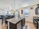 Beautiful kitchen features a large island with granite countertop, stainless steel appliances, and opens to the dining room at 2300 Mountain Sky Dr, Fort Lupton, CO 80621