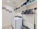 Laundry room with washer, dryer, and shelves at 2300 Mountain Sky Dr, Fort Lupton, CO 80621