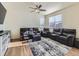 Spacious living room with large windows and a ceiling fan at 2300 Mountain Sky Dr, Fort Lupton, CO 80621