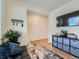 Bright living room with large TV, stylish storage, and cozy seating at 2300 Mountain Sky Dr, Fort Lupton, CO 80621