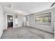 Bright living room featuring a sunroom and updated bathroom at 252 S Owens St, Byers, CO 80103