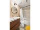 Stylish bathroom with a modern vanity, a round mirror, and a shower-over-tub with a marble tile surround at 7452 Singing Hills Dr, Boulder, CO 80301