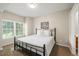 Bedroom featuring a comfortable queen-sized bed with an elegant iron frame and a sunlit window at 7452 Singing Hills Dr, Boulder, CO 80301