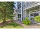 Exterior view of the condo with private balconies, complemented by mature trees and lush landscaping at 7452 Singing Hills Dr, Boulder, CO 80301