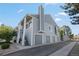Gray townhome with attached garages and staircase leading to upper level entrance at 7452 Singing Hills Dr, Boulder, CO 80301