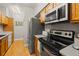 Galley kitchen featuring stainless steel appliances and wooden cabinets at 7452 Singing Hills Dr, Boulder, CO 80301