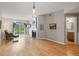 Open living room with hardwood floors, fireplace, and sliding door to balcony at 7452 Singing Hills Dr, Boulder, CO 80301