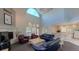 Open-concept living area with high ceilings, a fireplace, and an adjacent kitchen, ideal for entertaining at 7452 Singing Hills Dr, Boulder, CO 80301