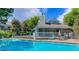 Sparkling pool surrounded by a sundeck and elegant building, perfect for relaxation and community enjoyment at 7452 Singing Hills Dr, Boulder, CO 80301
