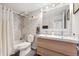 Modern bathroom featuring a double vanity, marble tile shower, and updated fixtures providing style at 1350 Josephine St # 307, Denver, CO 80206