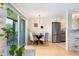 Stylish dining area features a glass table and chairs next to a sliding door and stainless steel fridge at 1350 Josephine St # 307, Denver, CO 80206
