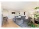 Bright living room featuring a comfortable gray sectional sofa and stylish decor at 1350 Josephine St # 307, Denver, CO 80206