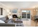 Cozy living room with fireplace, gray couch, and sliding glass door to the outside at 1350 Josephine St # 307, Denver, CO 80206