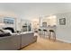 Open-concept living room featuring a gray sofa and a view of the kitchen with bar seating at 1350 Josephine St # 307, Denver, CO 80206