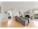 Comfortable living room with wood flooring, fireplace, TV, and view into the bedroom at 1350 Josephine St # 307, Denver, CO 80206