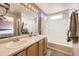 Ensuite bathroom with double vanity, tub, and shower at 14804 E 118Th Pl, Commerce City, CO 80603