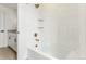 A clean bathroom showcases a white tub with tiled walls and bronze fixtures at 15499 Kearney St, Brighton, CO 80602