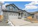 Beautiful home with a two-car garage, stone accents and manicured landscaping at 15499 Kearney St, Brighton, CO 80602