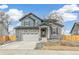 Charming two-story home with gray stone accents and a well-manicured front yard at 15499 Kearney St, Brighton, CO 80602