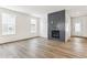 Bright living room featuring hardwood floors, a fireplace, and lots of natural light at 15499 Kearney St, Brighton, CO 80602