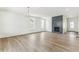 Bright living room with hardwood floors and a cozy fireplace with tile surround at 15499 Kearney St, Brighton, CO 80602