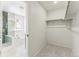 Spacious walk-in closet adjacent to bathroom, with neutral carpet and white walls at 15499 Kearney St, Brighton, CO 80602