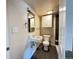 Bathroom featuring a pedestal sink, overhead storage, and a shower behind the door at 10130 W 20Th Ave, Lakewood, CO 80215