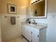 Classic bathroom features a vanity, mirror, and towel bar with decorative accents at 10130 W 20Th Ave, Lakewood, CO 80215