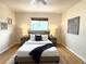 Comfortable bedroom features hardwood floors, a ceiling fan and an abundance of natural light at 10130 W 20Th Ave, Lakewood, CO 80215