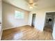 Well-lit bedroom with closet, hardwood floors and a ceiling fan at 10130 W 20Th Ave, Lakewood, CO 80215