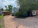 Exterior view of blue home with rock landscaping, a large tree, and partial brick finish at 10130 W 20Th Ave, Lakewood, CO 80215