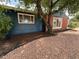 A close up of this lovely single Gathering home features a blue exterior with red brick and rock landscaping at 10130 W 20Th Ave, Lakewood, CO 80215